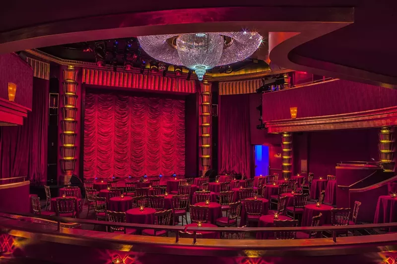 Image: The interior of the Faena Theater with a red velvet curtain and huge crystal chandelier