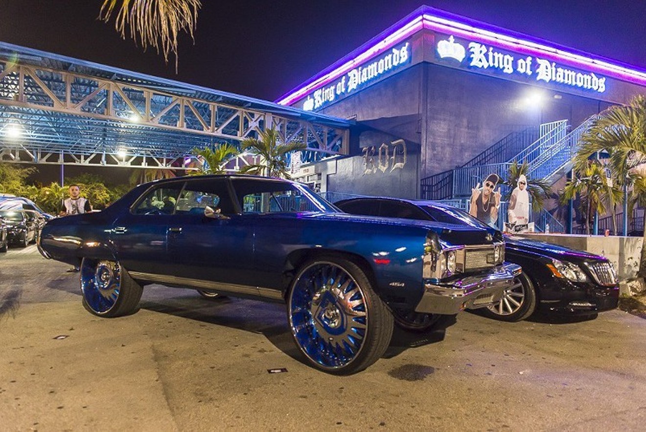 Cars sit outside the strip club King of Diamonds.