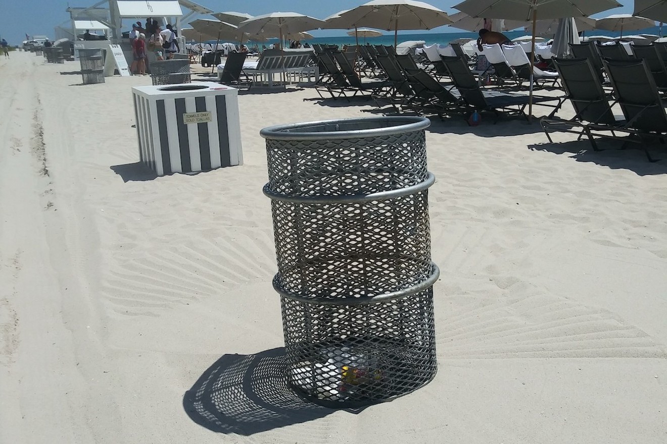 Trash cans such as this one line the Fontainebleau beach property, which is curiously empty of recycling bins.