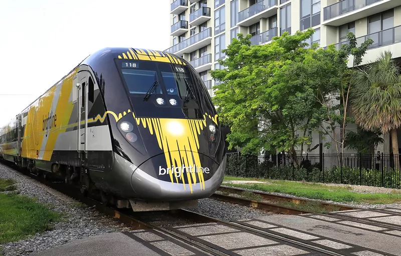 Image: A Brightline passenger train chugging down the tracks