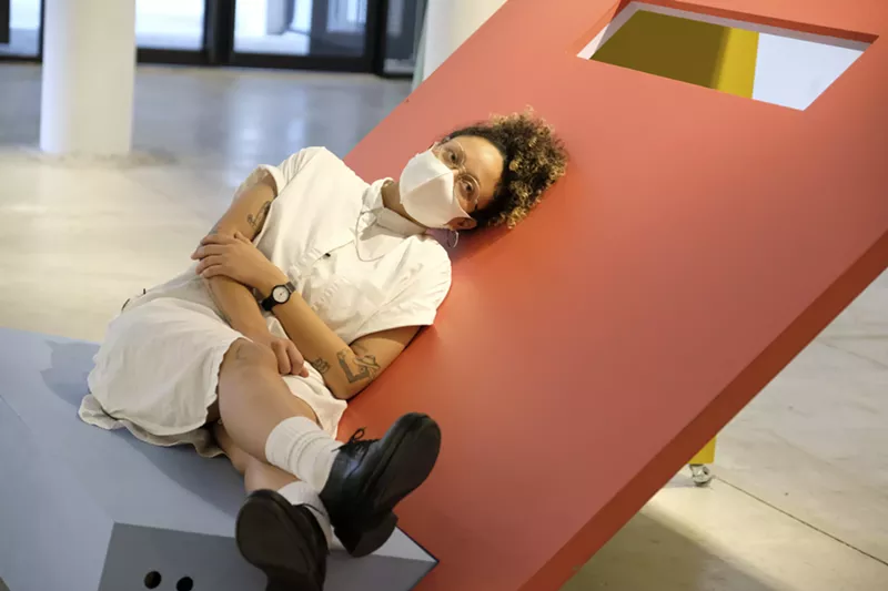 Image: Artist GeoVanna Gonzalez poses with her piece inside the Moore Building.