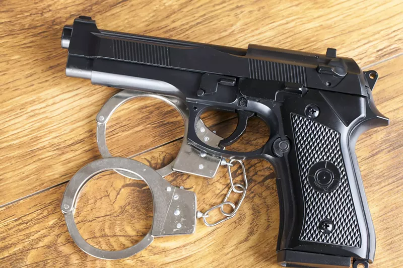 Image: Stock photo of a gun and handcuffs