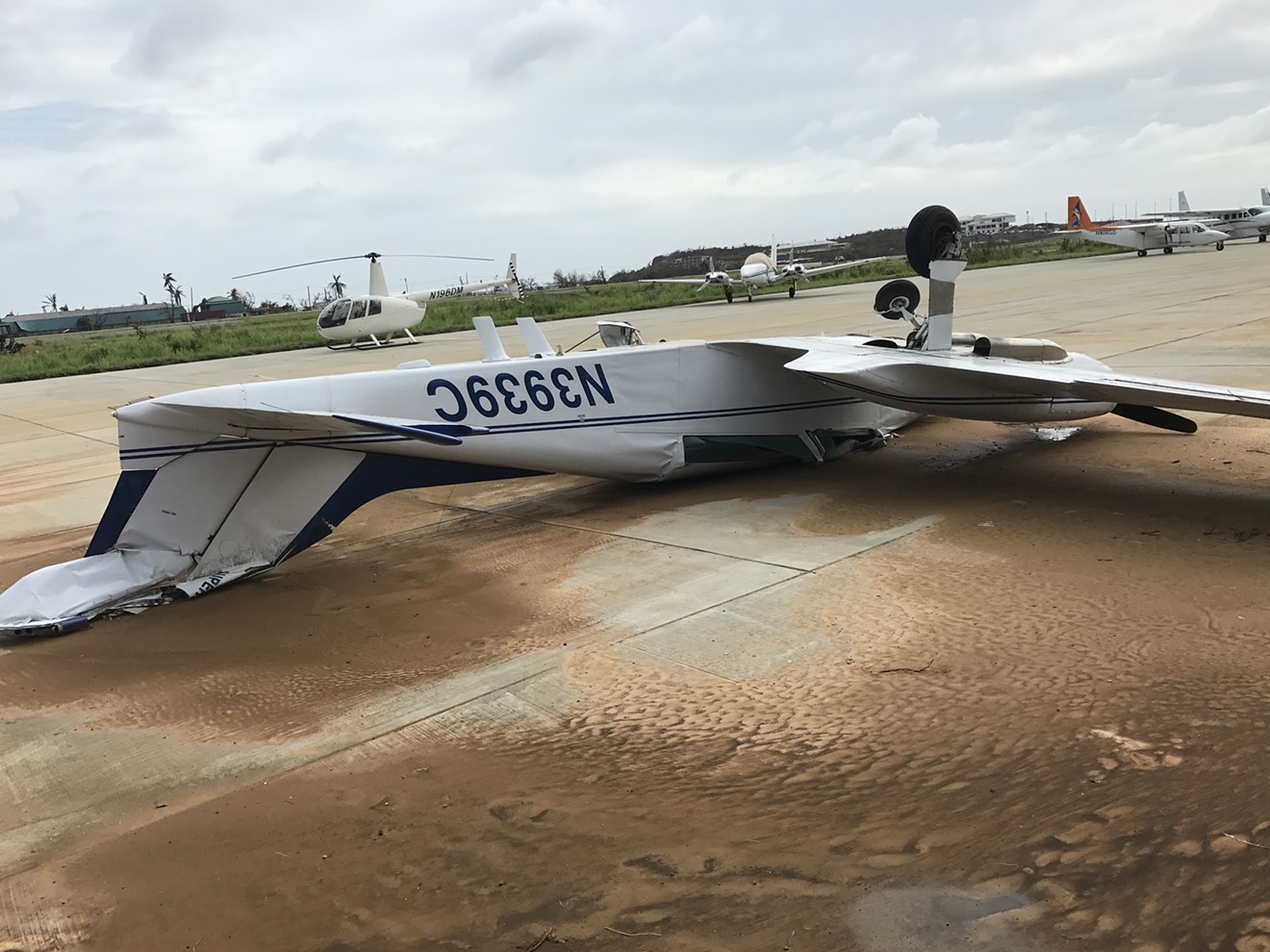 An upside-down plane, flipped by Irma, greets passengers in Saint Thomas.