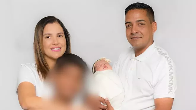 A photo of Yury Ussa Polania, her husband, her son, and her baby.