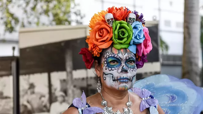 Woman painting as a sugar skull