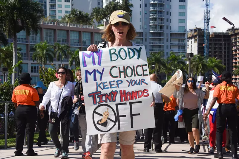 Image: A protester holds a sign at the Miami Women's March in 2017.