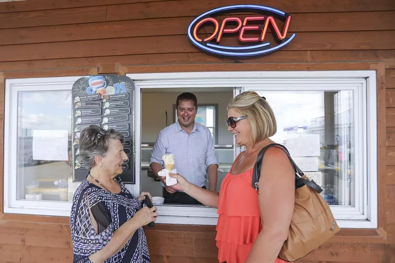 Image: two women in front of a service window at an ice cream stand