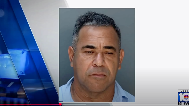 A mugshot of a man in a light blue polo