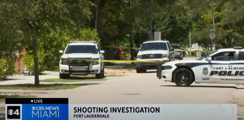Image: Screenshot of CBS Miami newscast showing Fort Lauderdale Police Department SUVs and caution tape on a street in Fort Lauderdale. The newscast banner reads, "Shooting Investigation Fort Lauderdale."