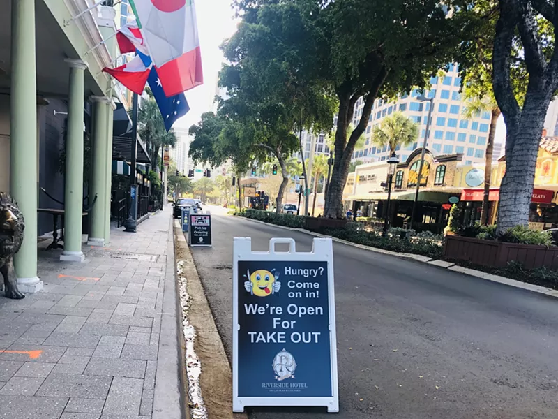 Image: Takeout signs greet passersby outside the Riverside Hotel on Las Olas Boulevard in Fort Lauderdale on Sunday, March 29, 2020.