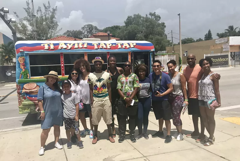 Image: Riders gather for a photo with the Little Haiti tour bus.