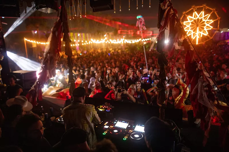 Image: DJ spinning before a massive crowd
