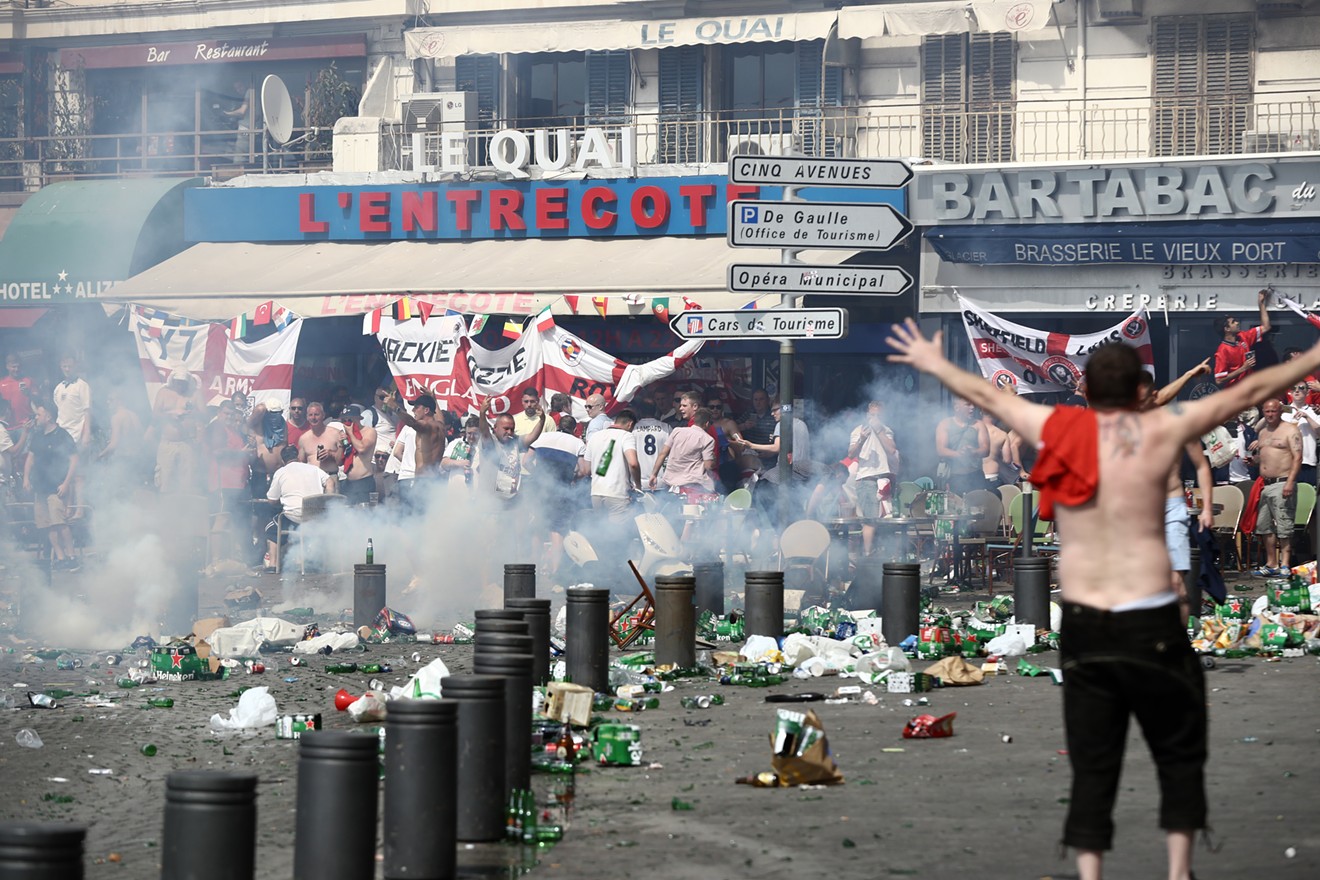 Rubbish lines the streets and beer bottles fly as England fans gather, cheer and clash with police ahead of a June 2016 soccer game against Russia in Marseille, France.