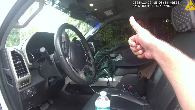 Image: Miami-Dade Police officer gives a thumbs up to one of the officers as he sits in the truck.