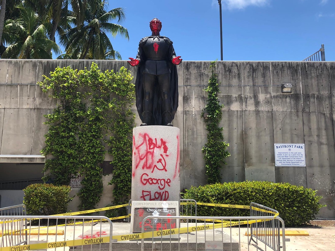 Protesters spray-painted a statue of Christopher Columbus in Bayfront Park.