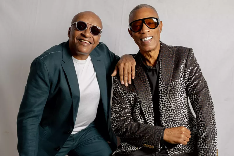 Image: Portrait of two bold men wearing sunglasses.