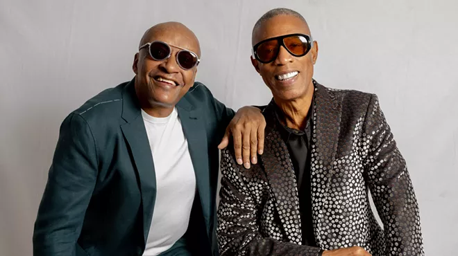 Portrait of two bold men wearing sunglasses.
