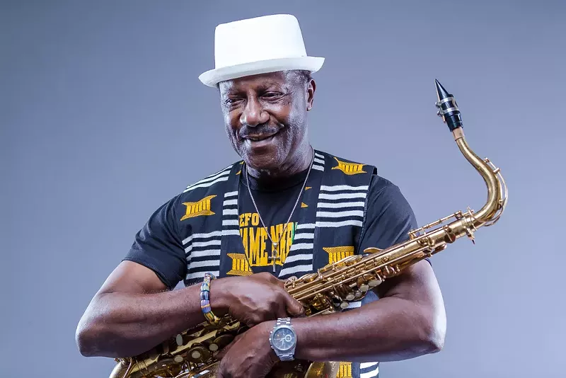 Image: Picture of a black man holding a saxophone.