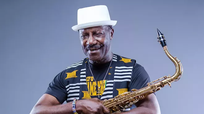 Picture of a black man holding a saxophone.