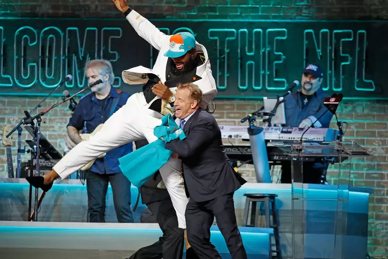 Image: Christian Wilkins jump into NFL Commissioner Roger Goodell after he is drafted by the Miami Dolphins during the 2019 NFL Draft in Nashville.