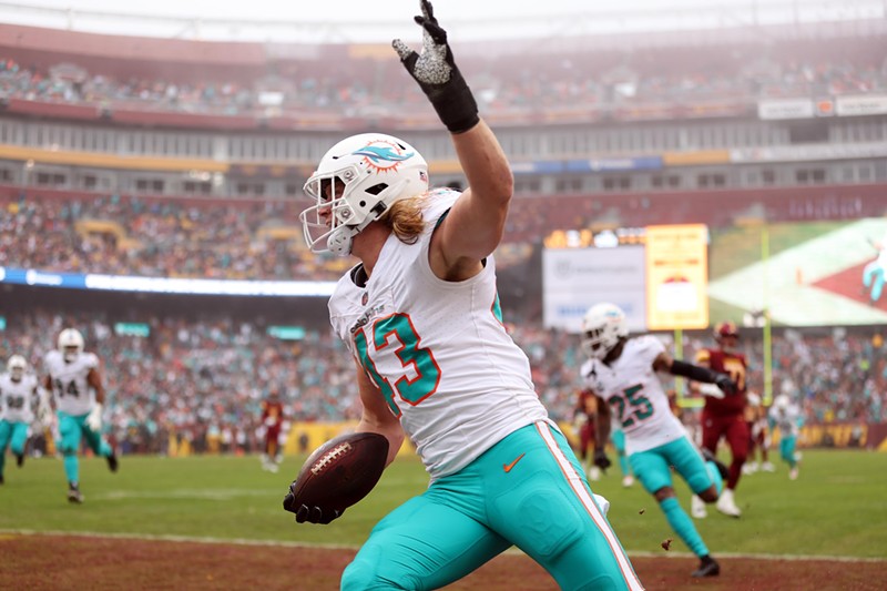 The Miami Dolphins' Andrew Van Ginkel celebrates after returning an interception for a touchdown against the Washington Commanders at FedExField on December 03, 2023.