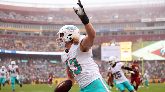 Dolphins linebacker Andrew Van Ginkel waves his hand in the air while celebrating a pick-6 against the Commanders.