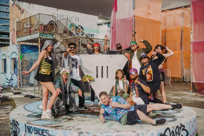 Image: Festivalgoers posing for a photo by the III Points logo