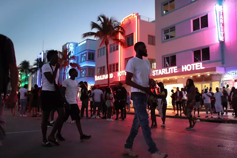 Image: Spring breakers stroll along Ocean Drive.