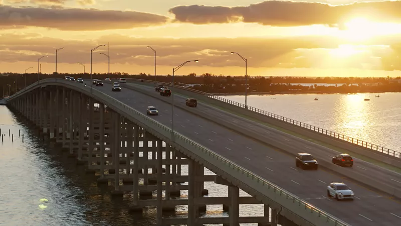 Image: Aerial view of a causeway in Key Biscayne, Florida, as the sun sets in the background