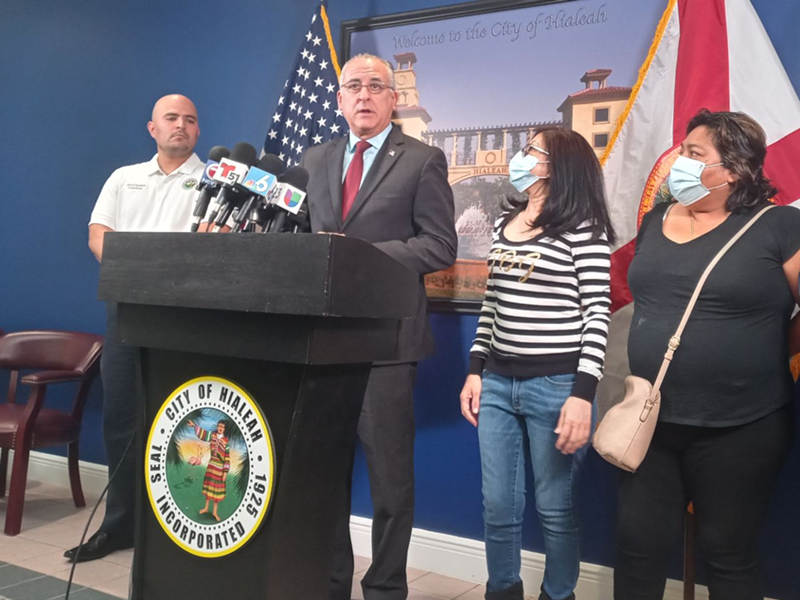 Image: Hialeah Mayor Esteban "Steve" Bovo, Jr. (center), addresses reporters to discuss rental assistance for residents experiencing massive rent hikes in the city.