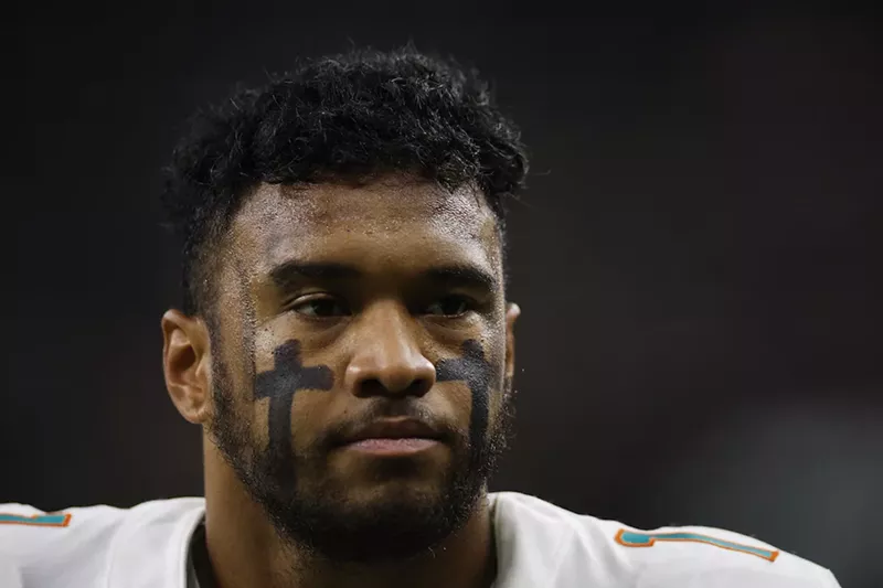 Image: Tua Tagovailoa #1 of the Miami Dolphins looks on during pregame warm-ups prior to a game against the New Orleans Saints at Caesars Superdome on December 27, 2021 in New Orleans, Louisiana
