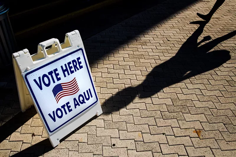 Image: A Vote Here sign outside a Miami Beach polling location.