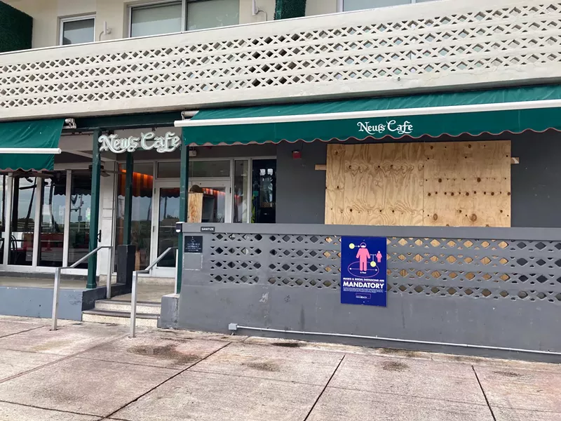 Image: Boarded-up windows at News Cafe.