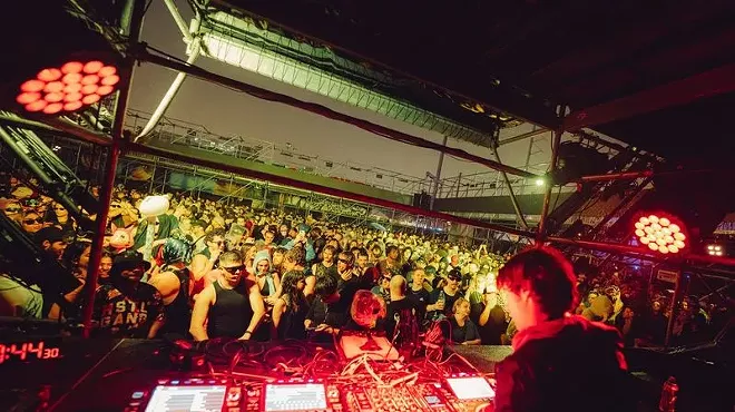Picture of a DJ in front of a crowd.