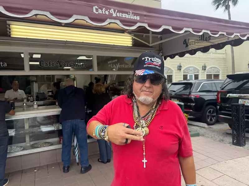 Image: a man outside a restaurant