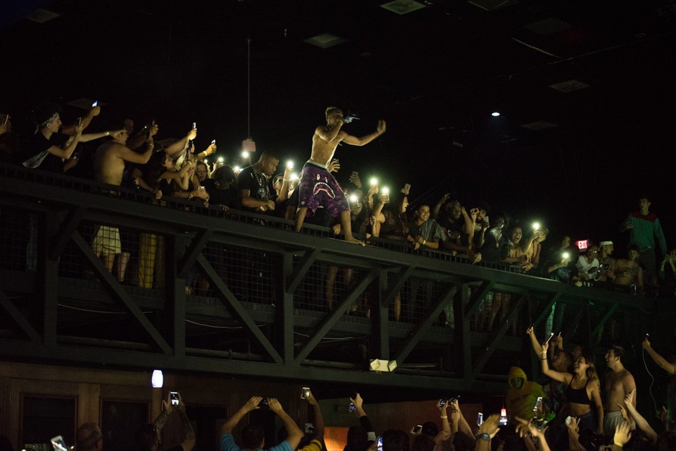 XXXTentacion hypes the crowd from the upper level of Club Cinema. See more photos from XXXTentacion's performance at Club Cinema here.