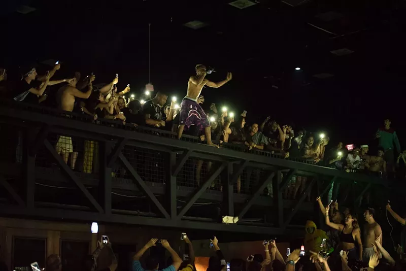 Image: XXXTentacion hypes the crowd from the upper level of Club Cinema. See more photos from XXXTentacion's performance at Club Cinema here.