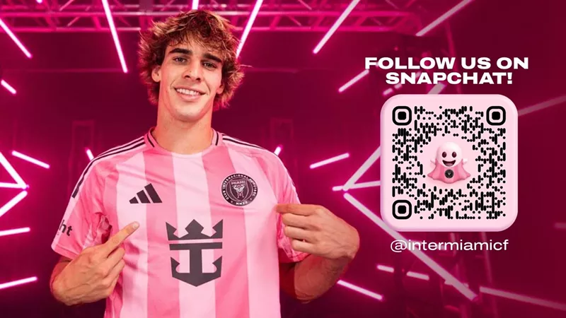 Image: Someone wearing a striped pink soccer jersey with a pink background featuring pink laser beams