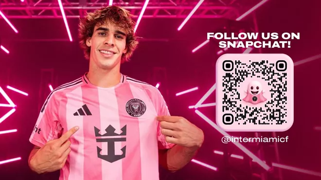Someone wearing a striped pink soccer jersey with a pink background featuring pink laser beams