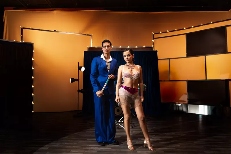 Image: Picture of Isabela Merced and Tony Succar posing in front of a piano.