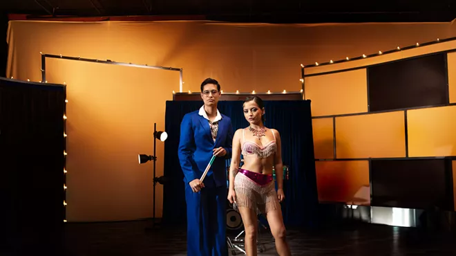 Picture of Isabela Merced and Tony Succar posing in front of a piano.