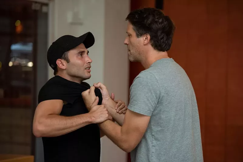 Image: Ernesto Reyes's Justin (left) tries to defend himself from Caleb Scott's David in the world premiere of Borrowed.