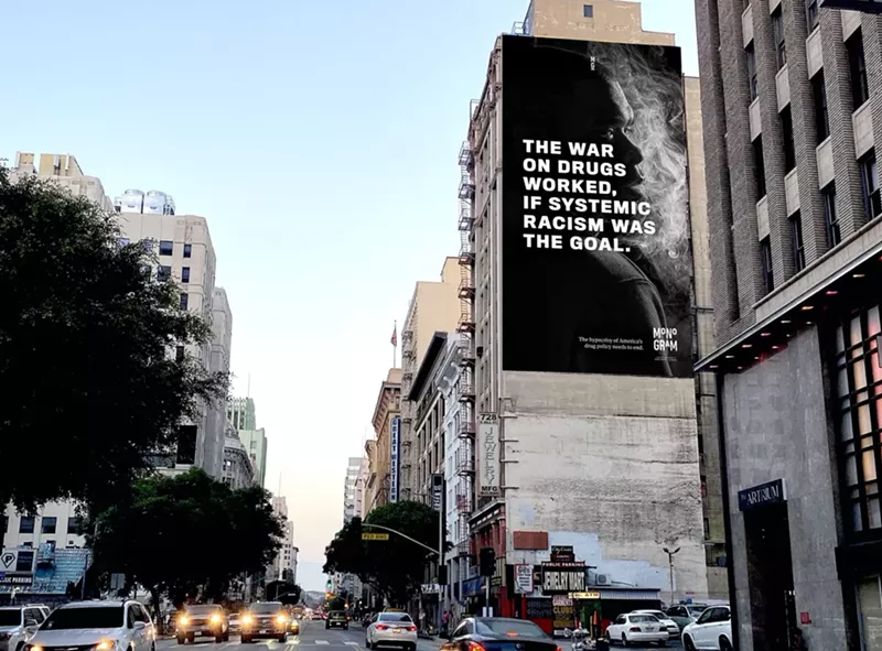 Image: The signs include portraits of people who have been arrested for cannabis-related offenses.