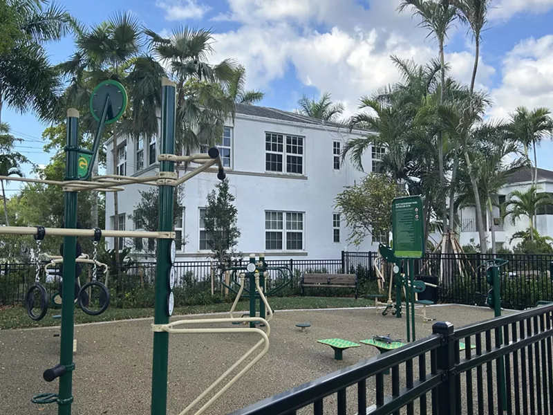 Image: East Shenandoah Park and an outdoor gym that sits behind a white residential building.