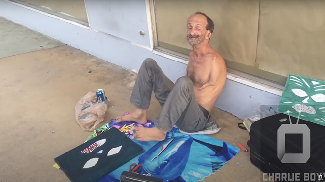 Jonathan Crenshaw, a well-known homeless South Beach street artist with no arms, paints a canvas using his feet.