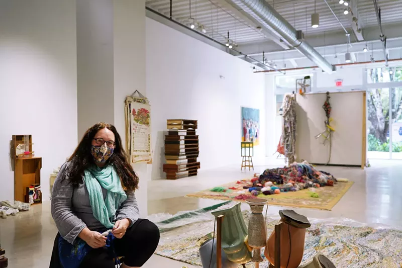 Image: Artist Kerry Phillips at her installation An Accidental Collection (The Junk Drawer) in the Design District.