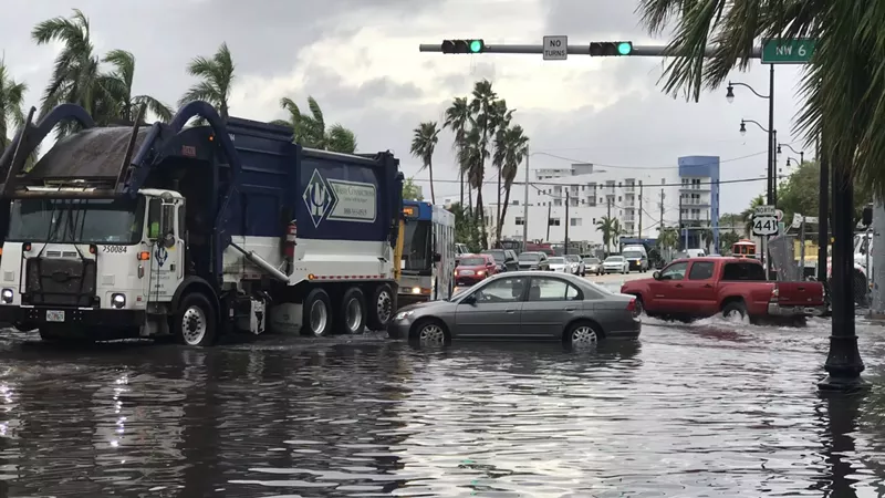 Image: Cars and a garbage truck at the flooded intersection of NW Sixth Street and NW Seventh Avenue in Miami in an undated photo