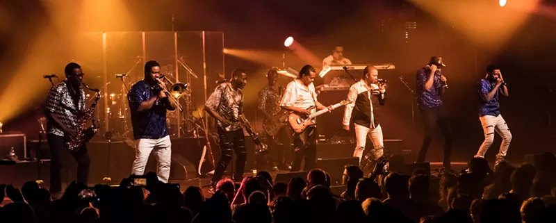 Image: Picture of a band performing on stage.
