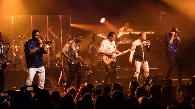 Picture of a band performing on stage.
