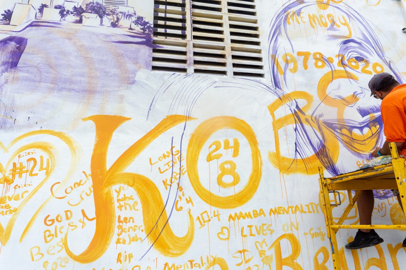 Artist Kyle Holbrook paints a mural paying tribute to late basketball player Kobe Bryant.